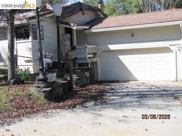 20280 Little Valley Road Groveland, CA 95321 - Photo 18 of 24 View of property exterior featuring driveway and an attached garage