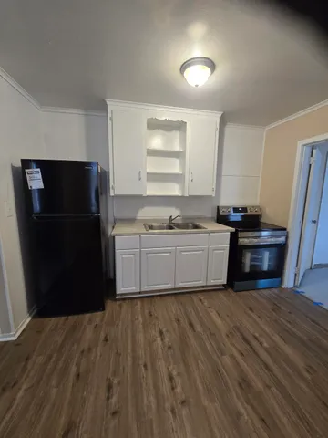 a kitchen with a sink and a refrigerator