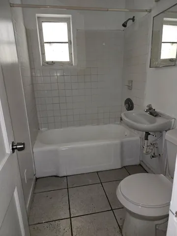 a bathroom with a sink a toilet and bathtub