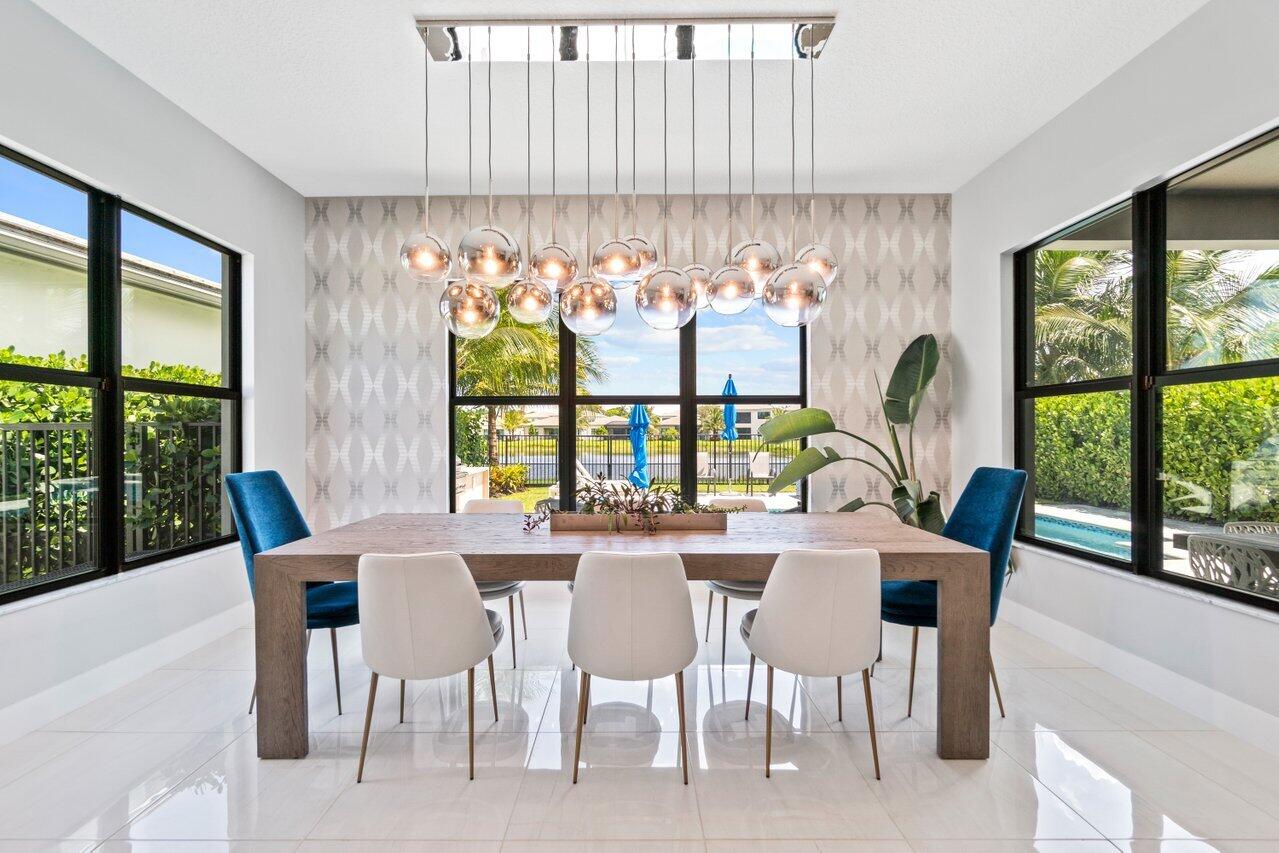 8618 Tower Bridge Court Boca Raton, FL 33496 - Photo 12 of 47 a dining room with furniture a chandelier and large windows