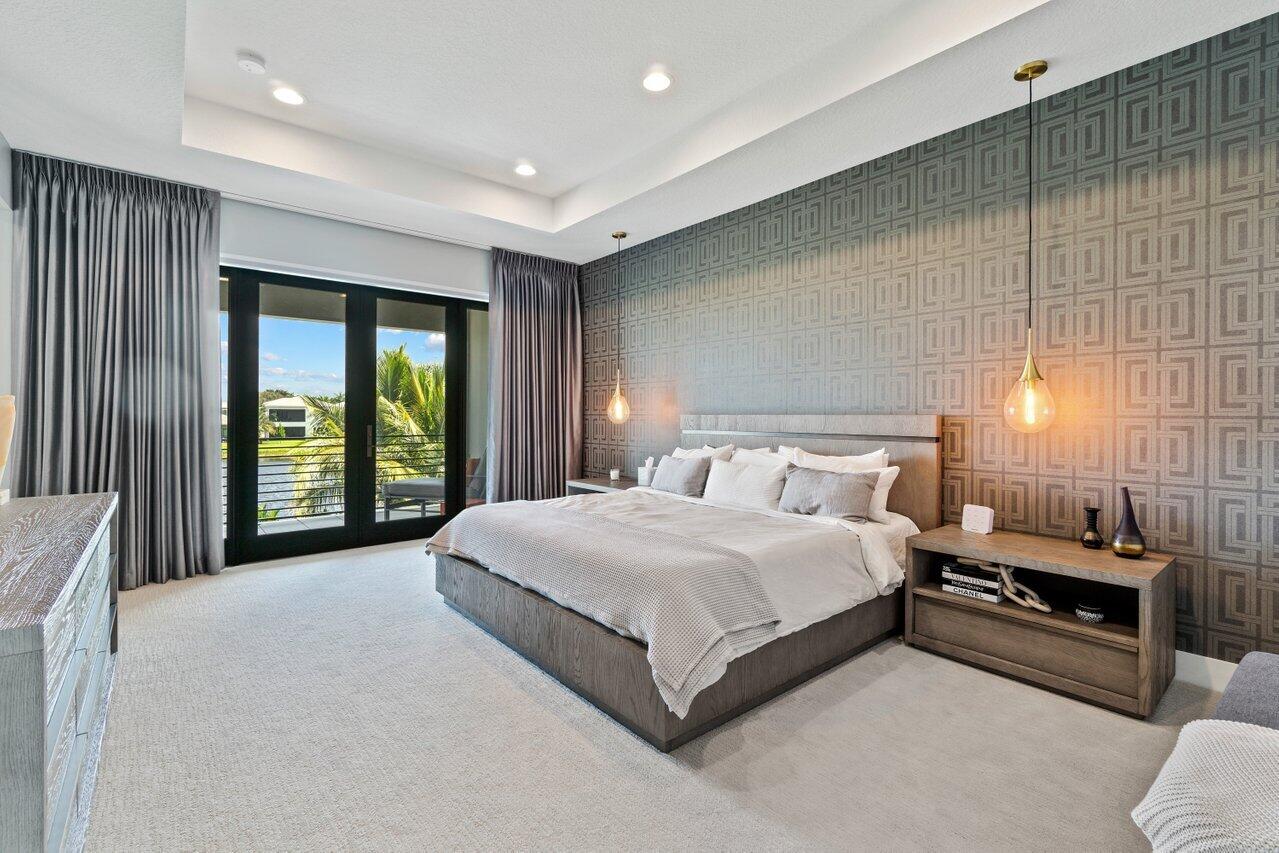 8618 Tower Bridge Court Boca Raton, FL 33496 - Photo 16 of 47 a spacious bedroom with a large bed and a large window