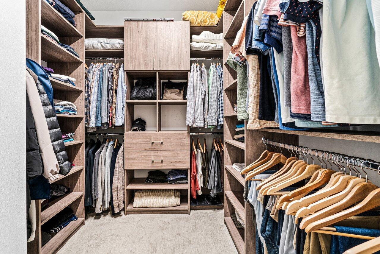 8618 Tower Bridge Court Boca Raton, FL 33496 - Photo 18 of 47 a view of walk in closet with clothes and shoes