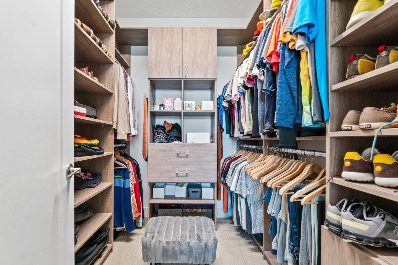 8618 Tower Bridge Court Boca Raton, FL 33496 - Photo 19 of 47 a view of walk in closet with clothes and shoes