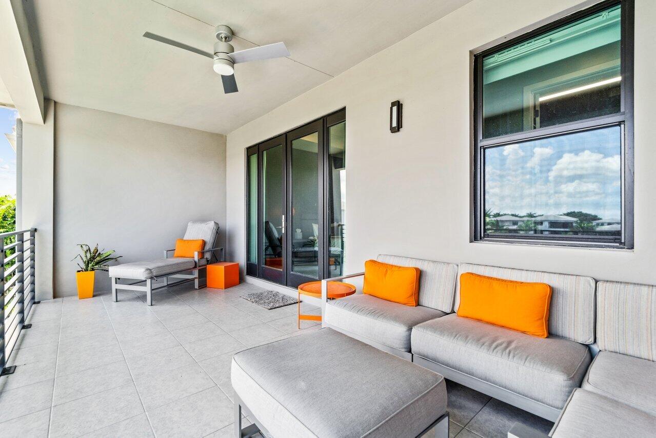 8618 Tower Bridge Court Boca Raton, FL 33496 - Photo 22 of 47 a blue couch sitting in a living room next to a window