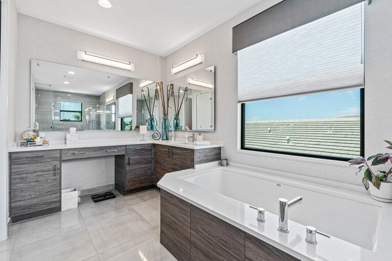 8618 Tower Bridge Court Boca Raton, FL 33496 - Photo 26 of 47 a bathroom with a sink a large mirror and a bathtub