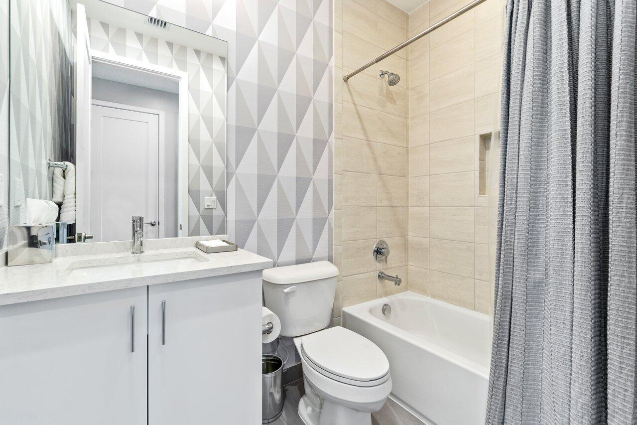 8618 Tower Bridge Court Boca Raton, FL 33496 - Photo 33 of 47 a bathroom with a granite countertop sink toilet a mirror and shower