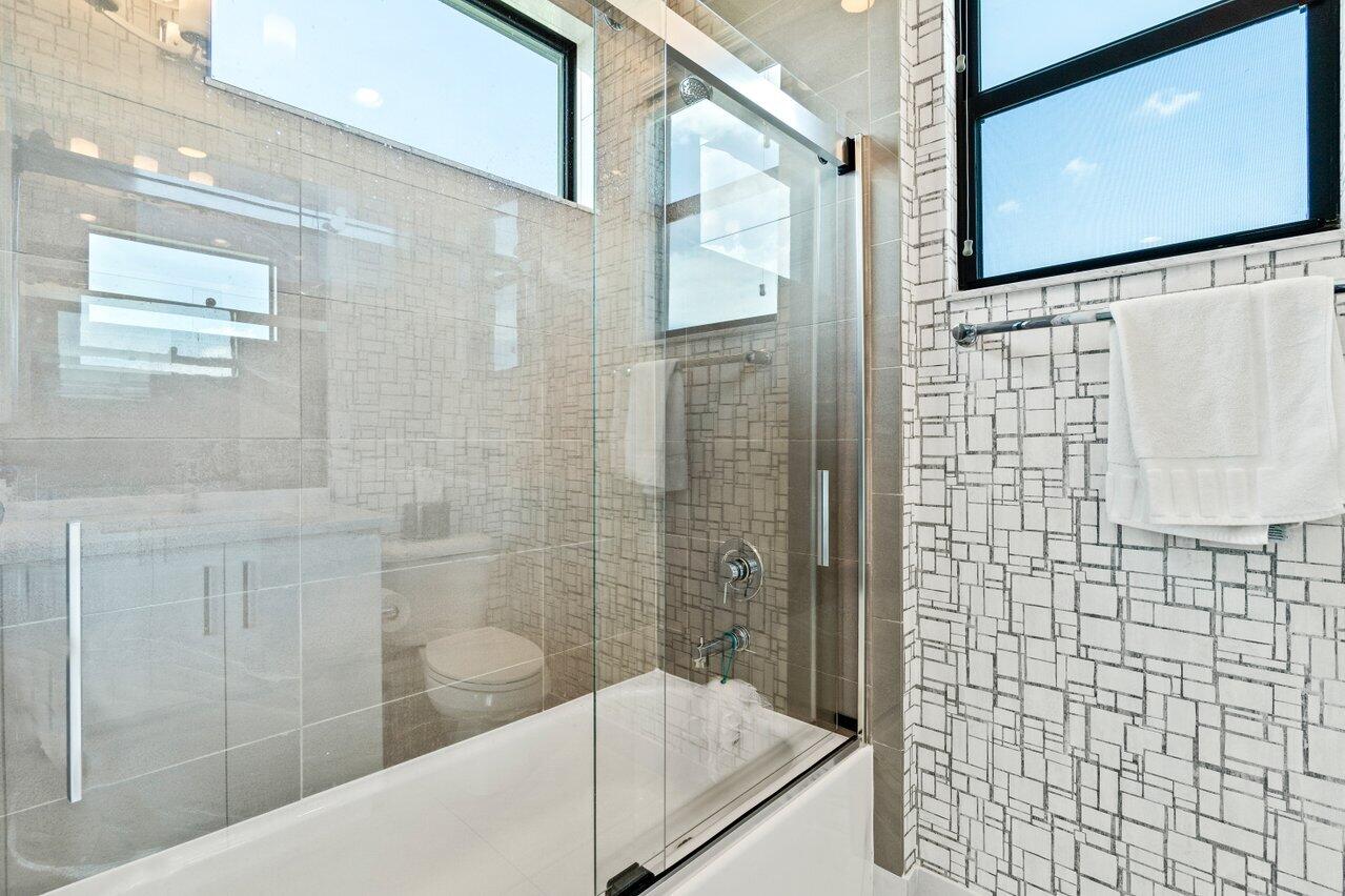 8618 Tower Bridge Court Boca Raton, FL 33496 - Photo 34 of 47 a bathroom with a shower