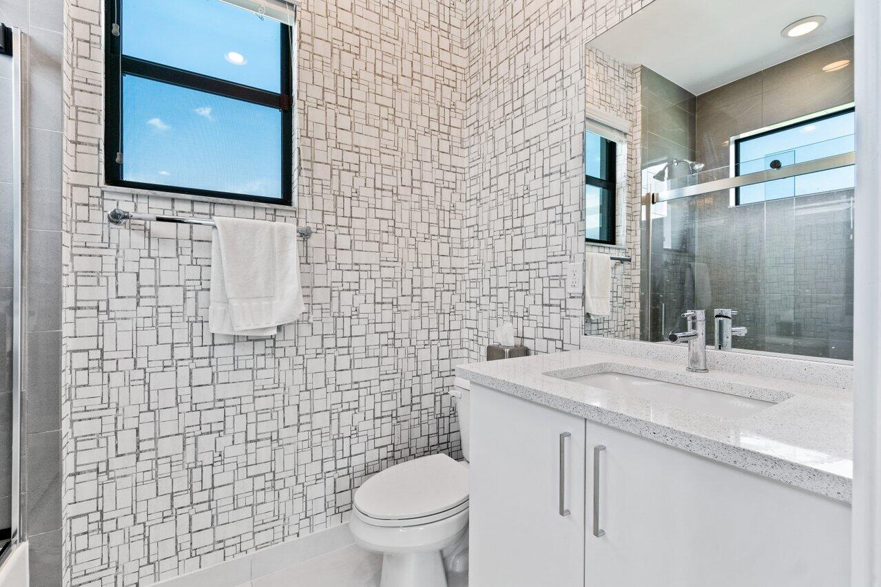 8618 Tower Bridge Court Boca Raton, FL 33496 - Photo 35 of 47 a bathroom with a sink a toilet and mirror