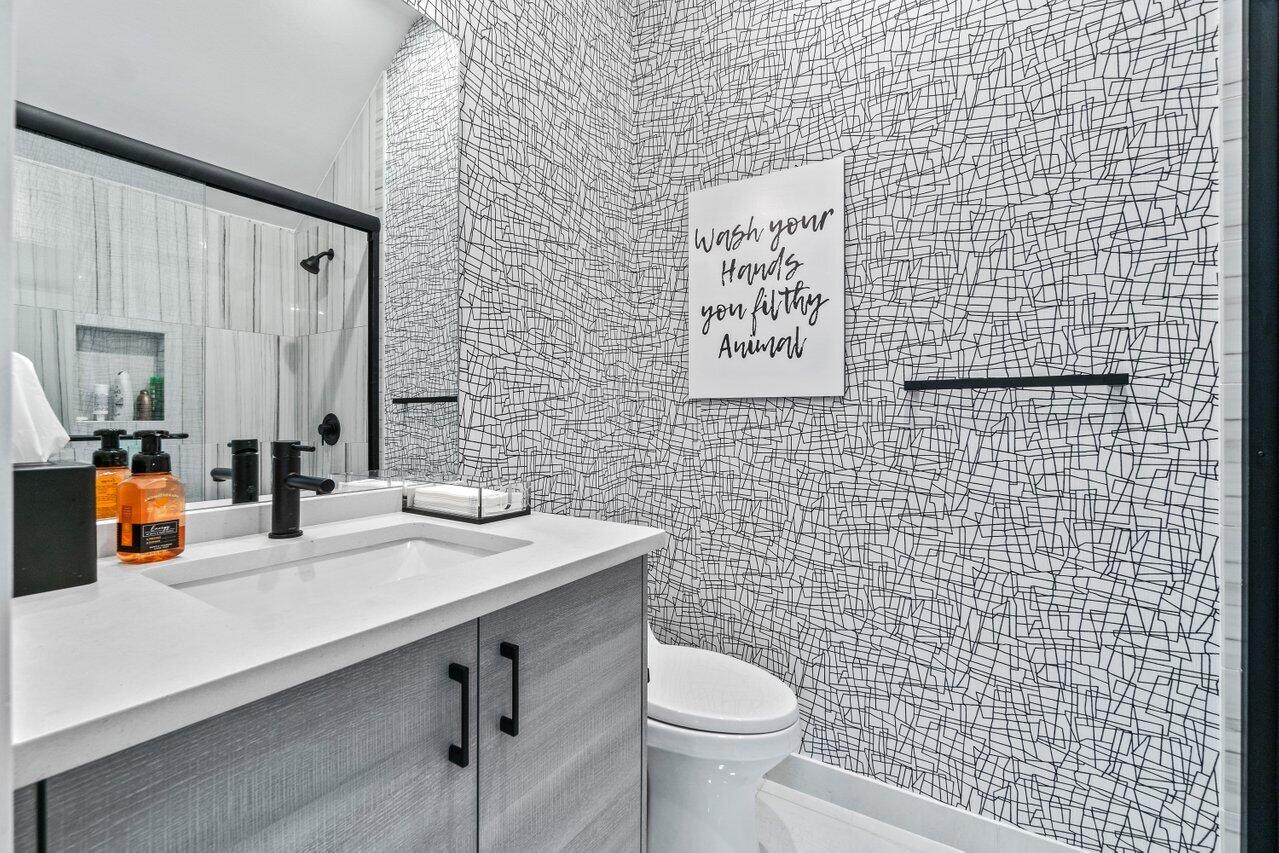 8618 Tower Bridge Court Boca Raton, FL 33496 - Photo 40 of 47 a bathroom with a sink a toilet and mirror