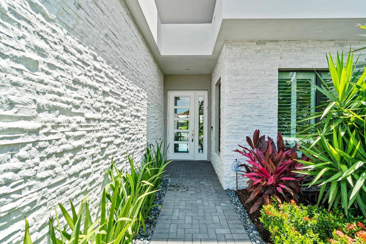 8618 Tower Bridge Court Boca Raton, FL 33496 - Photo 4 of 47 a potted plant sitting in front of a building