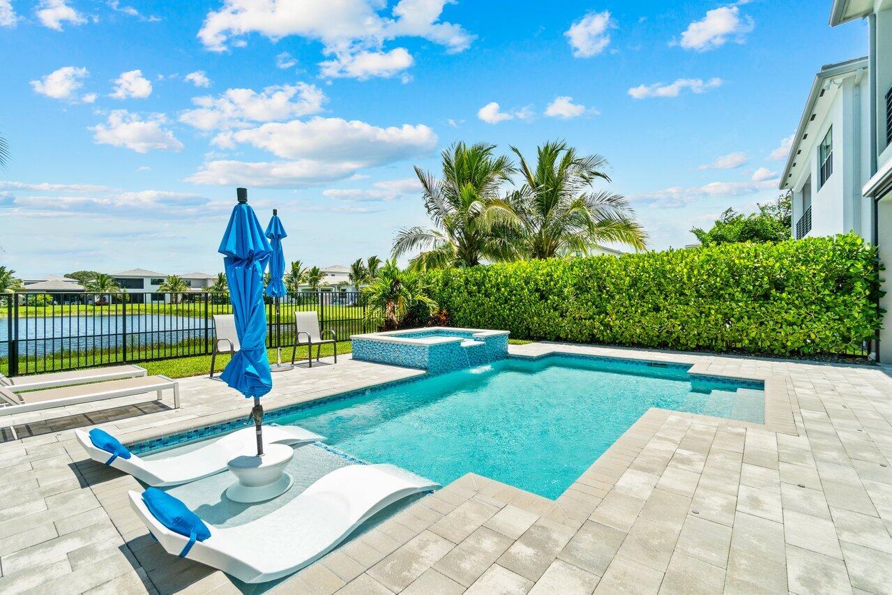 8618 Tower Bridge Court Boca Raton, FL 33496 - Photo 42 of 47 a front view of a house with garden