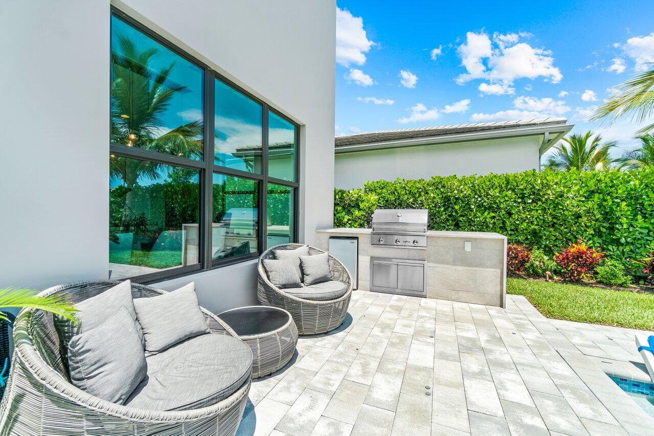 8618 Tower Bridge Court Boca Raton, FL 33496 - Photo 45 of 47 a view of a patio with couches chairs and a fire pit