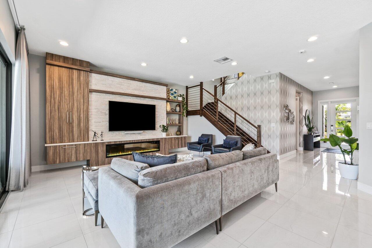 8618 Tower Bridge Court Boca Raton, FL 33496 - Photo 7 of 47 a living room with furniture and a flat screen tv