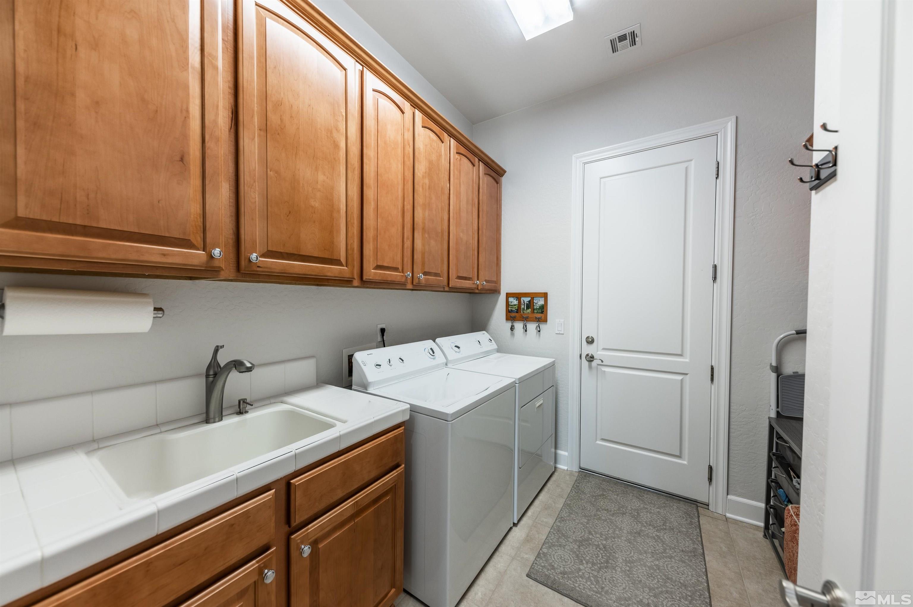 1291 Meridian Ranch Drive Reno, NV 89523 - Photo 23 of 30 a view of a storage and utility room with sink dryer and washer