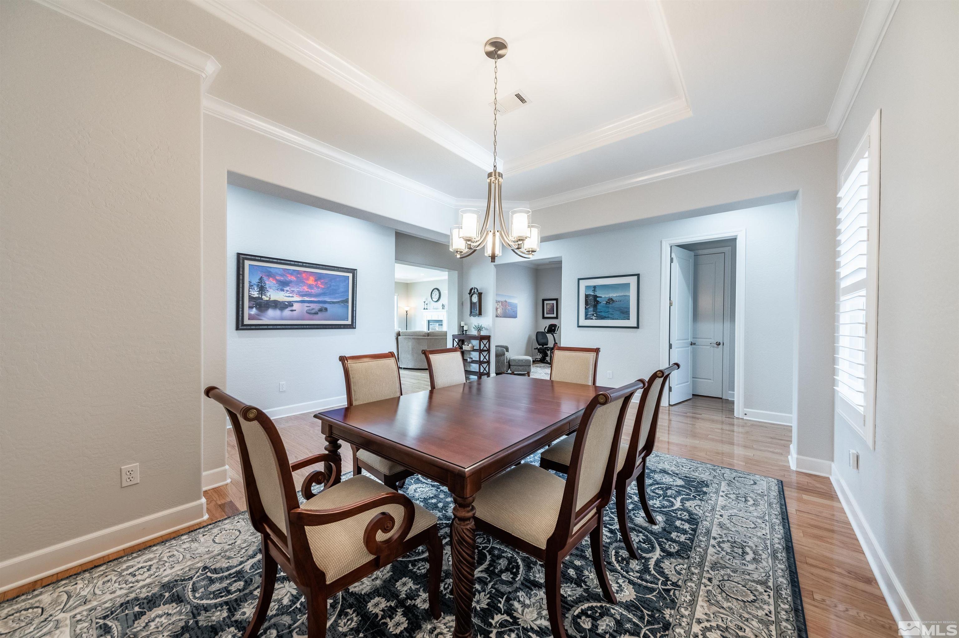 1291 Meridian Ranch Drive Reno, NV 89523 - Photo 4 of 30 a dining room with furniture a chandelier and wooden floor