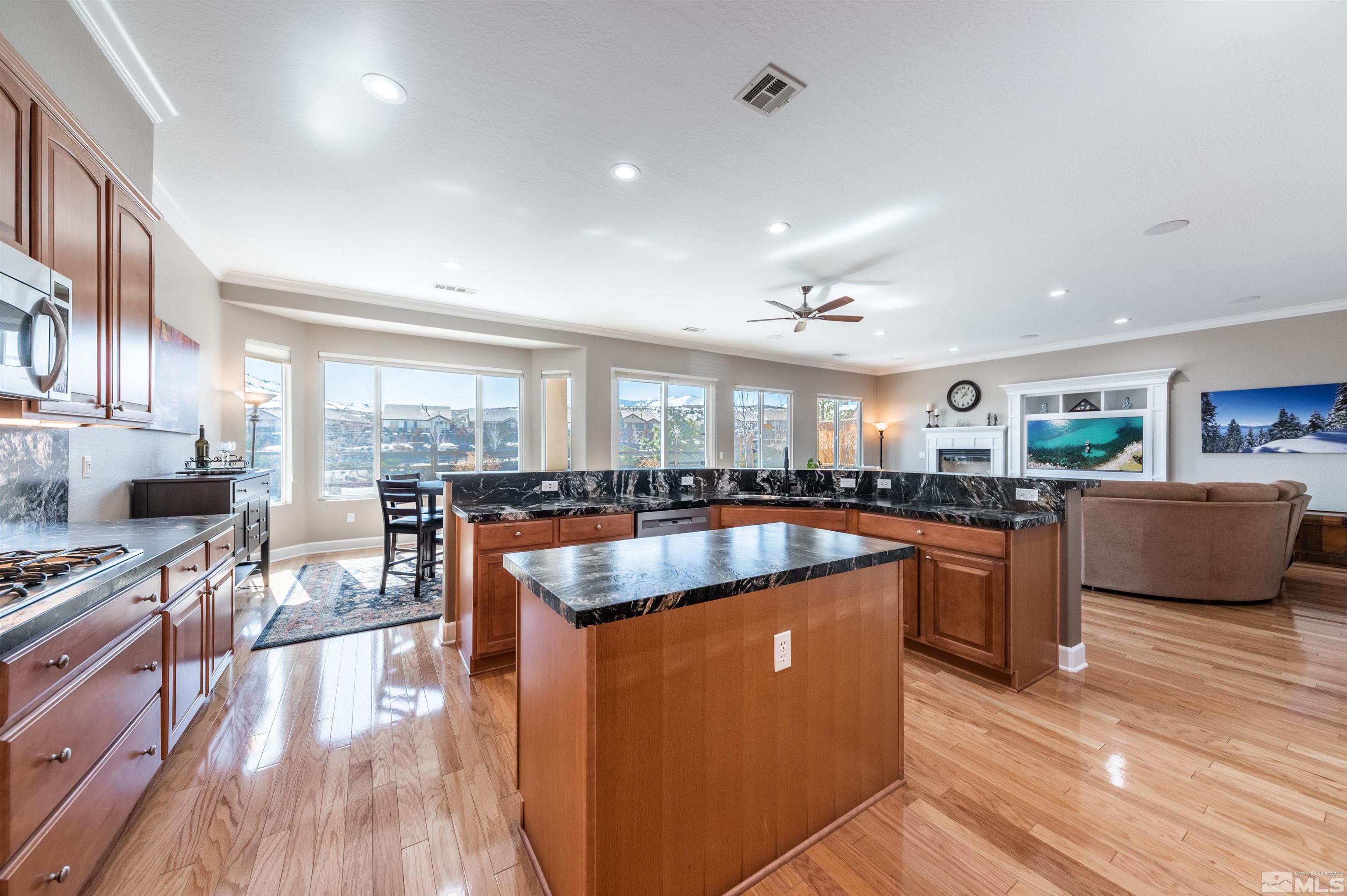 1291 Meridian Ranch Drive Reno, NV 89523 - Photo 6 of 30 a kitchen with stainless steel appliances granite countertop a refrigerator a sink a stove and a wooden floors