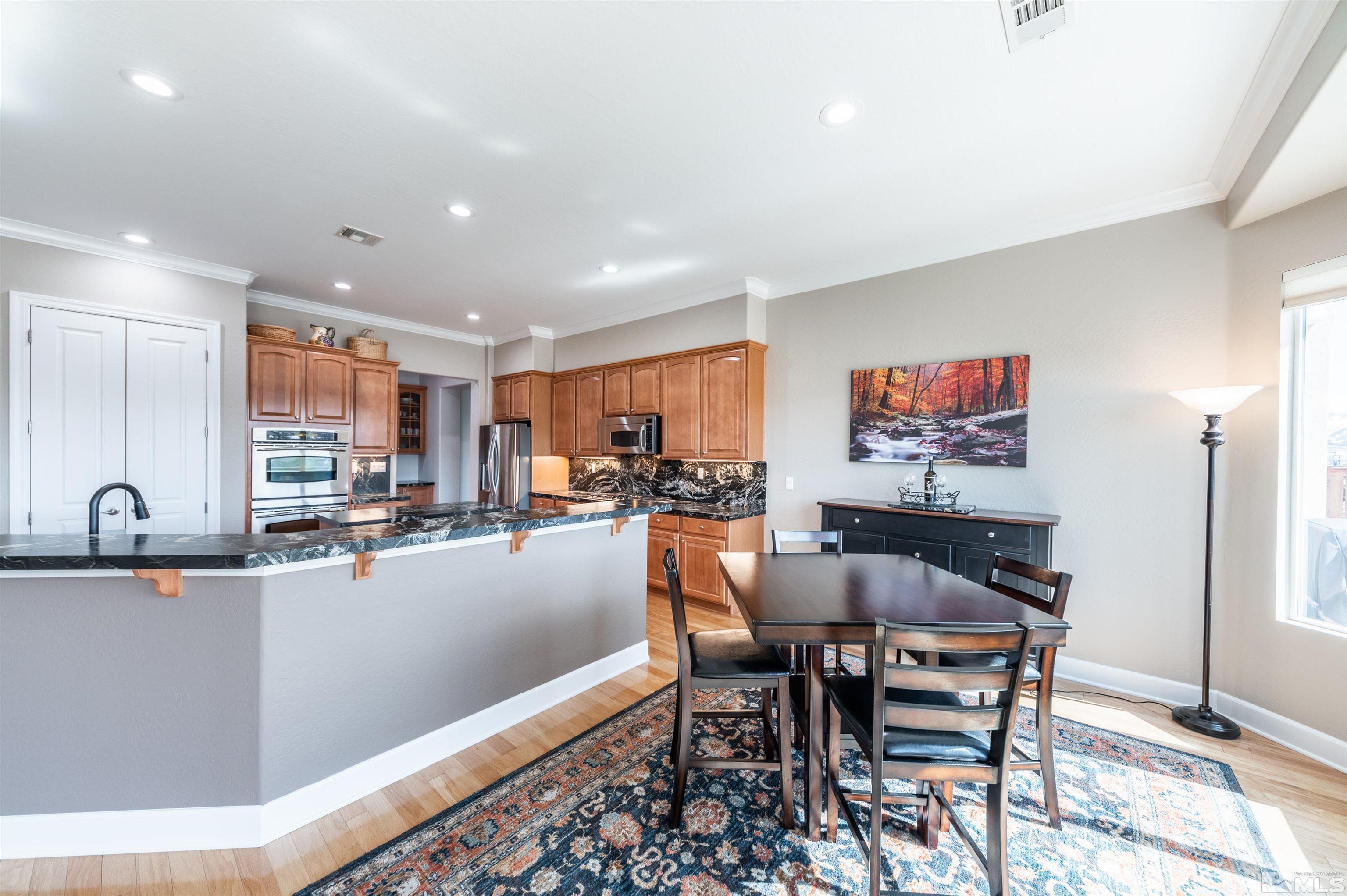 1291 Meridian Ranch Drive Reno, NV 89523 - Photo 9 of 30 a dining hall with stainless steel appliances a dining table and chairs