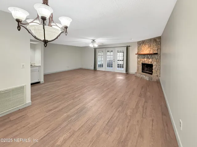 a view of a livingroom with a fireplace and wooden floor