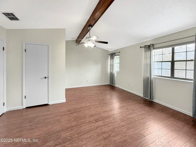 wooden floor in an empty room with a window