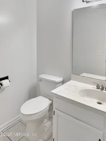 a white toilet sitting next to a bathroom sink