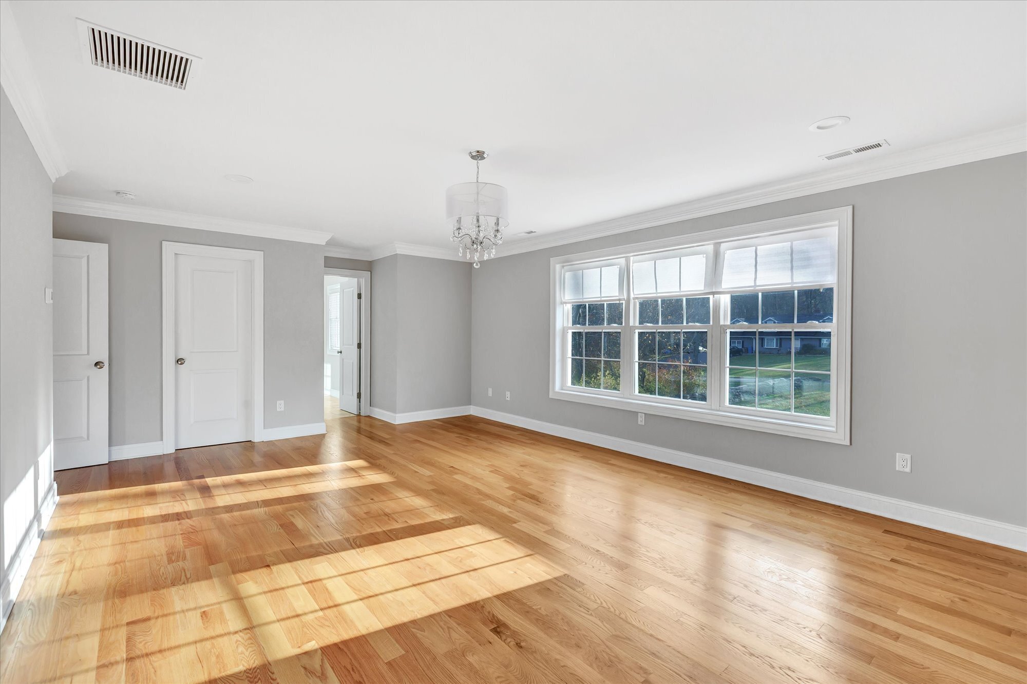 191 Meadow Street Shelton, CT 06484 - Photo 18 of 40 a view of an empty room with wooden floor and a window