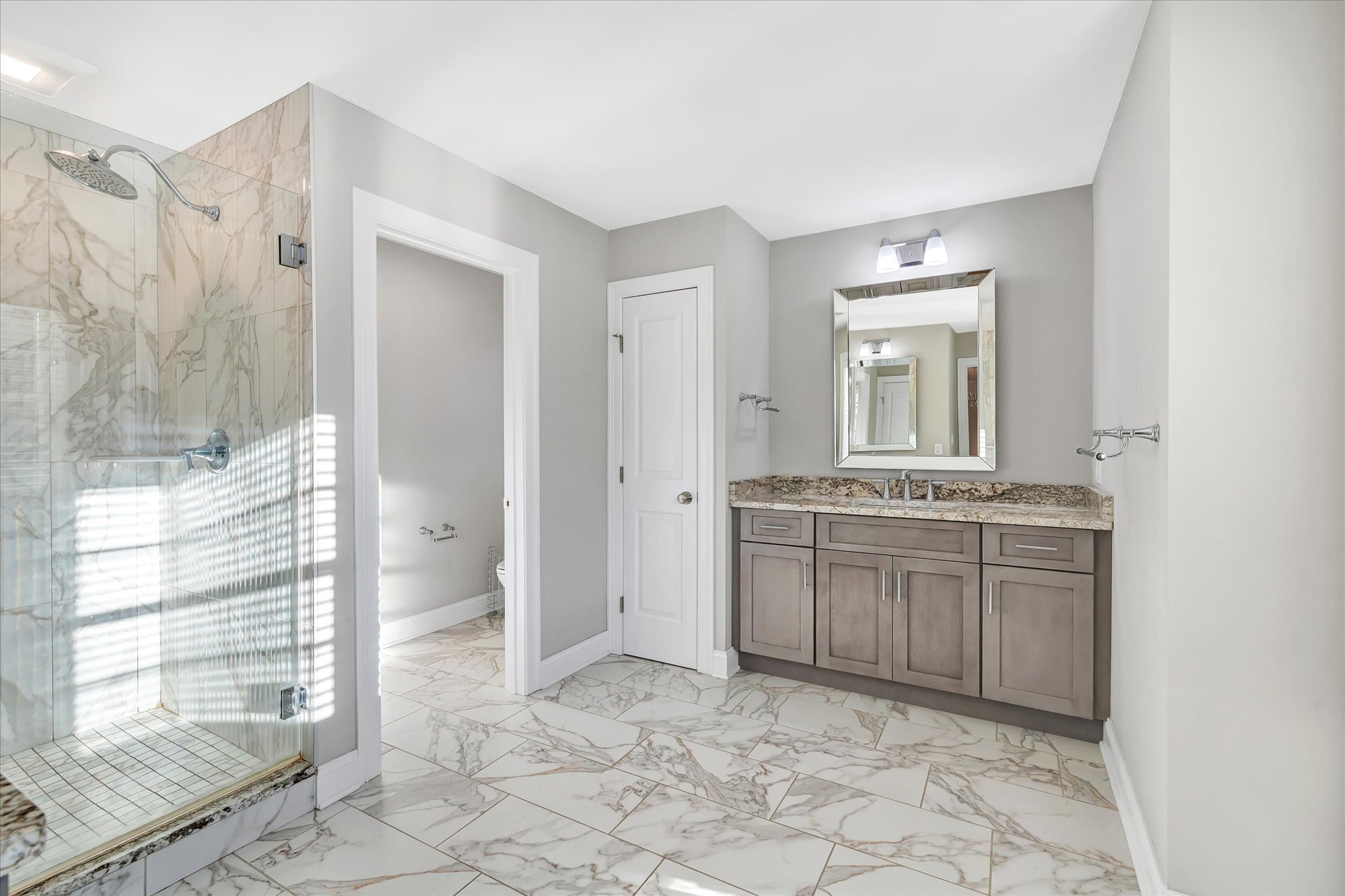 191 Meadow Street Shelton, CT 06484 - Photo 21 of 40 a bathroom with a granite countertop sink a mirror and a shower