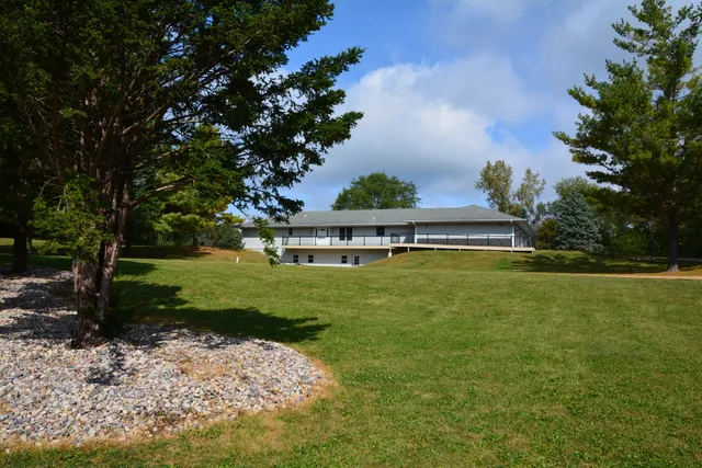 a view of yard with swimming pool and trees