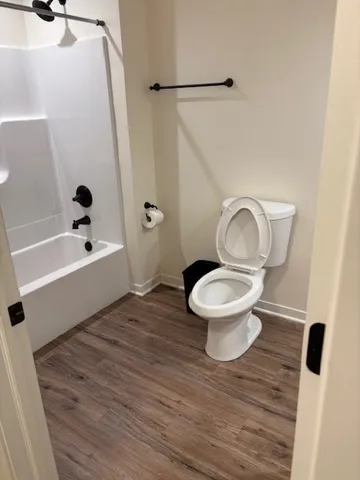 a bathroom with a toilet and a shower