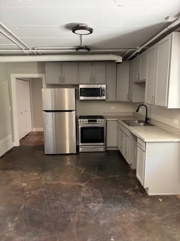a kitchen with a sink and a refrigerator