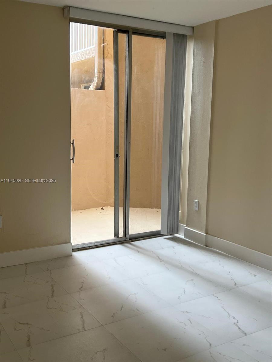 10801 Southwest 109th Court, Unit D110 Miami, FL 33176 - Photo 11 of 25 a view of an empty room with a window
