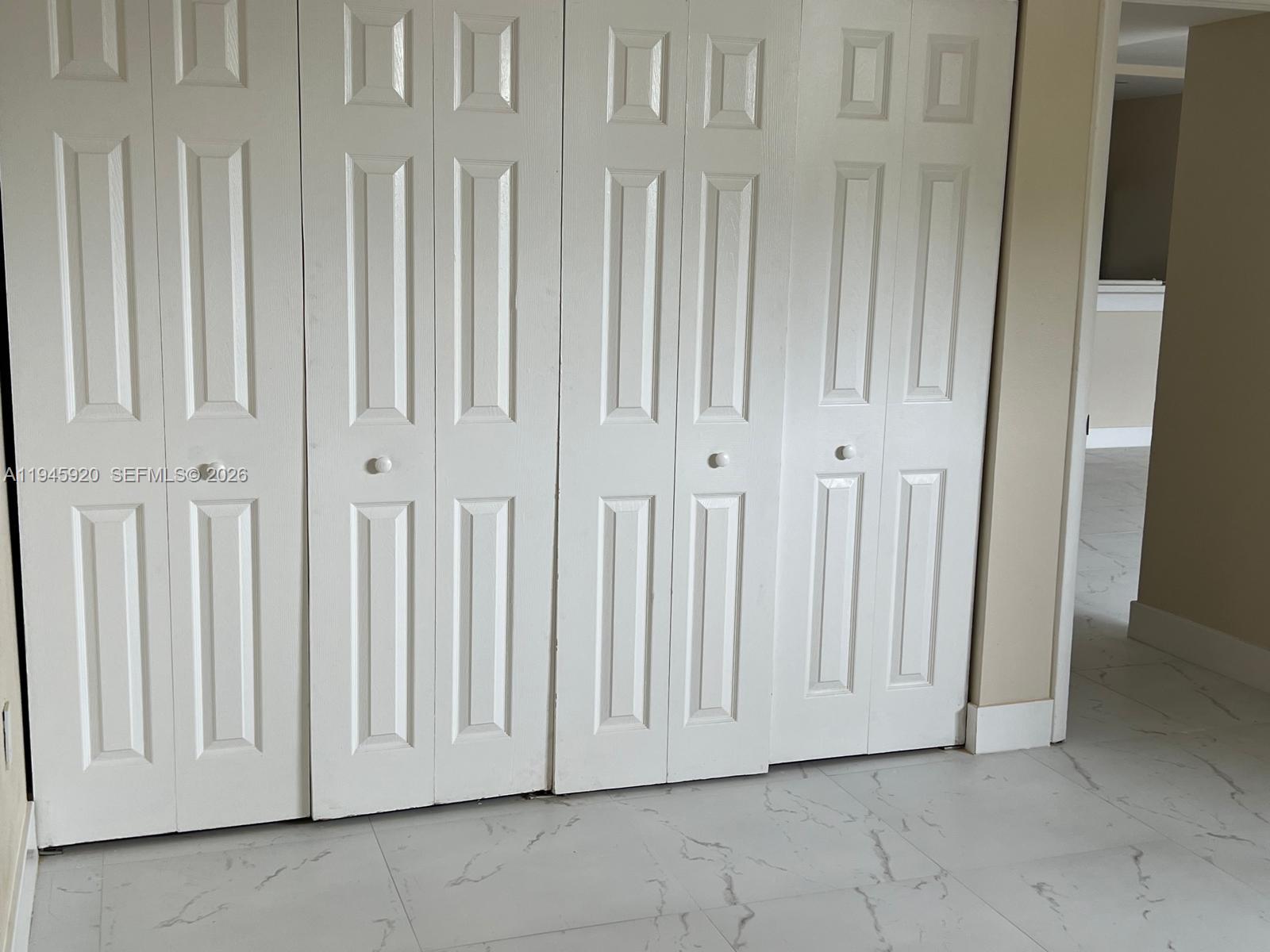 10801 Southwest 109th Court, Unit D110 Miami, FL 33176 - Photo 17 of 25 an empty room with a wooden door