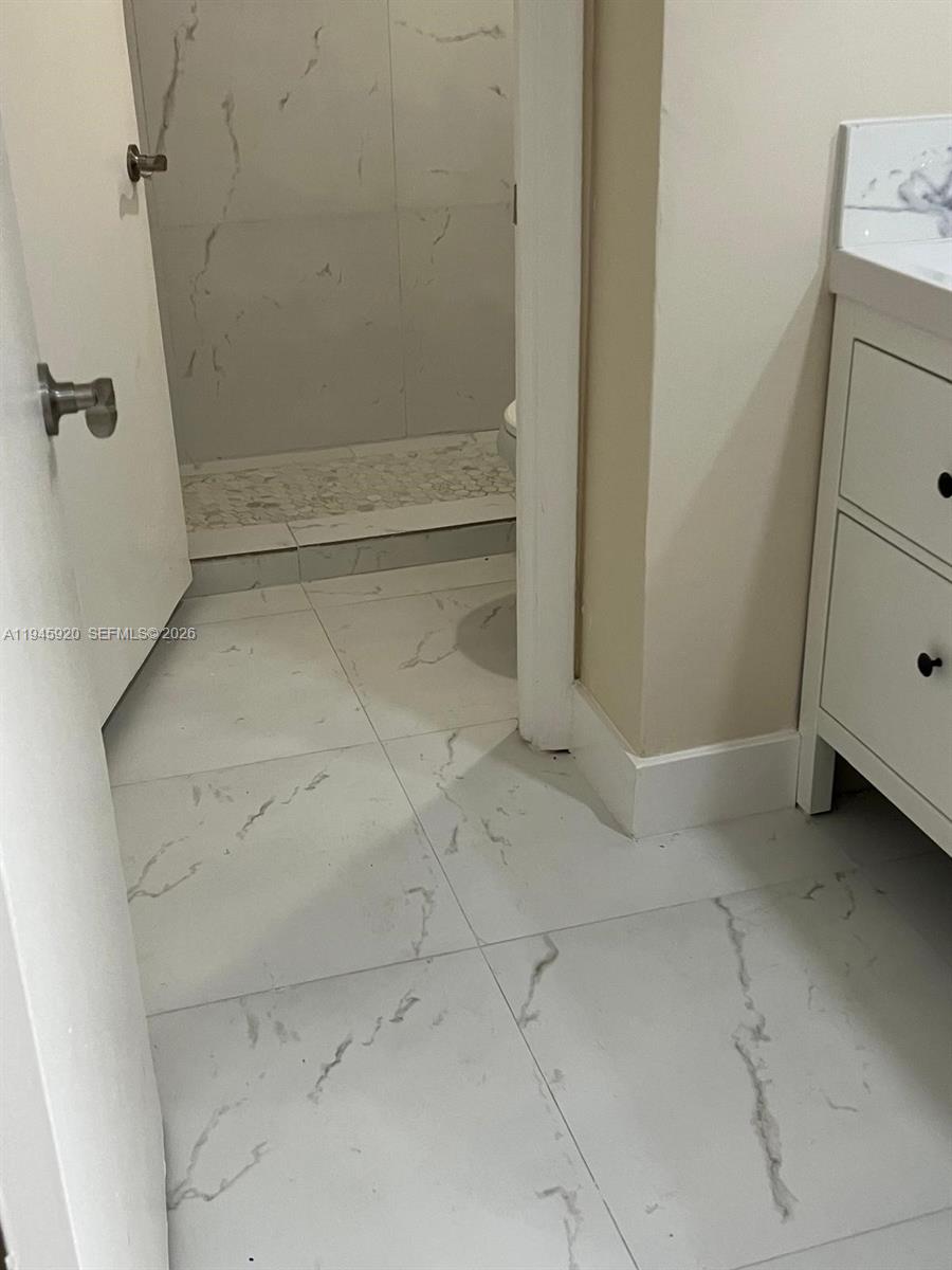 10801 Southwest 109th Court, Unit D110 Miami, FL 33176 - Photo 20 of 25 a view of room with racks on the wall