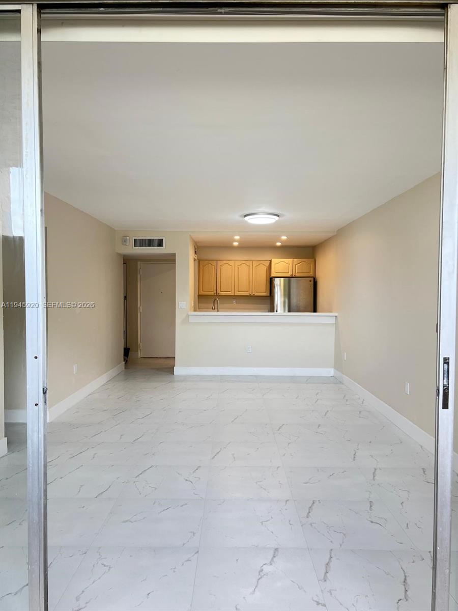 10801 Southwest 109th Court, Unit D110 Miami, FL 33176 - Photo 2 of 25 a view of a big room with wooden floor and cabinet
