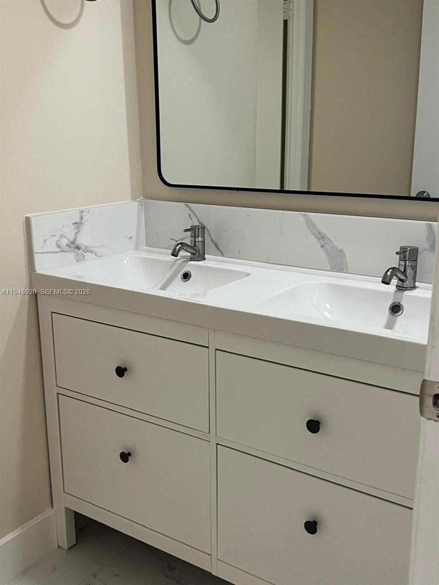 10801 Southwest 109th Court, Unit D110 Miami, FL 33176 - Photo 21 of 25 a bathroom with a sink and mirror