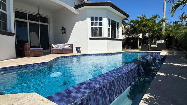 a view of a house with backyard porch and sitting area