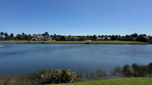 a view of a lake with houses in the background