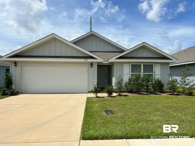 7409 Brompton Drive Foley, AL 36535 - Photo 18 of 18 View of front of house with a garage and a front lawn