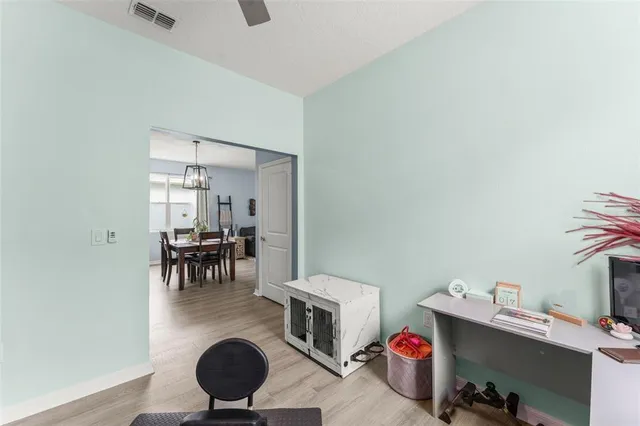 a living room with furniture and a dining room