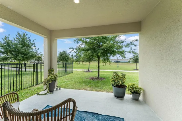 a view of a porch with furniture and garden