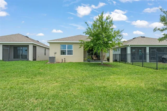 a view of a house with yard and tree s