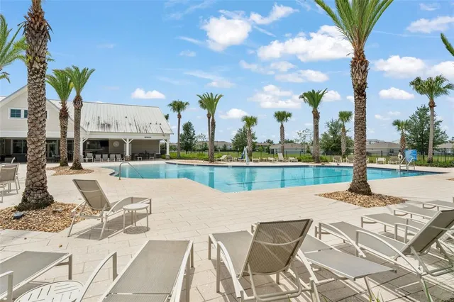 a view of swimming pool with outdoor seating and city view