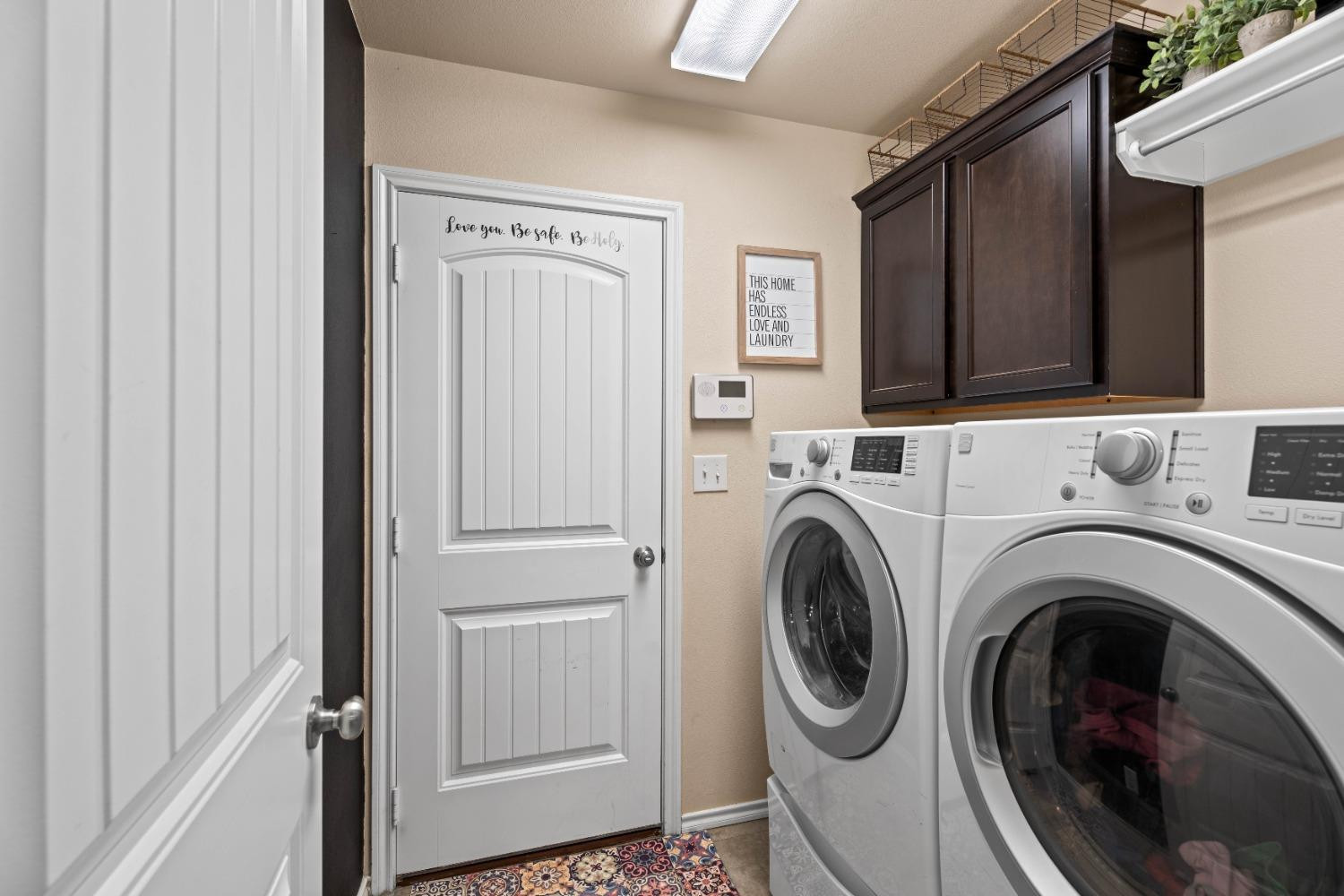 7349 100th Street Lubbock, TX 79424 - Photo 12 of 21 a utility room with dryer and washer