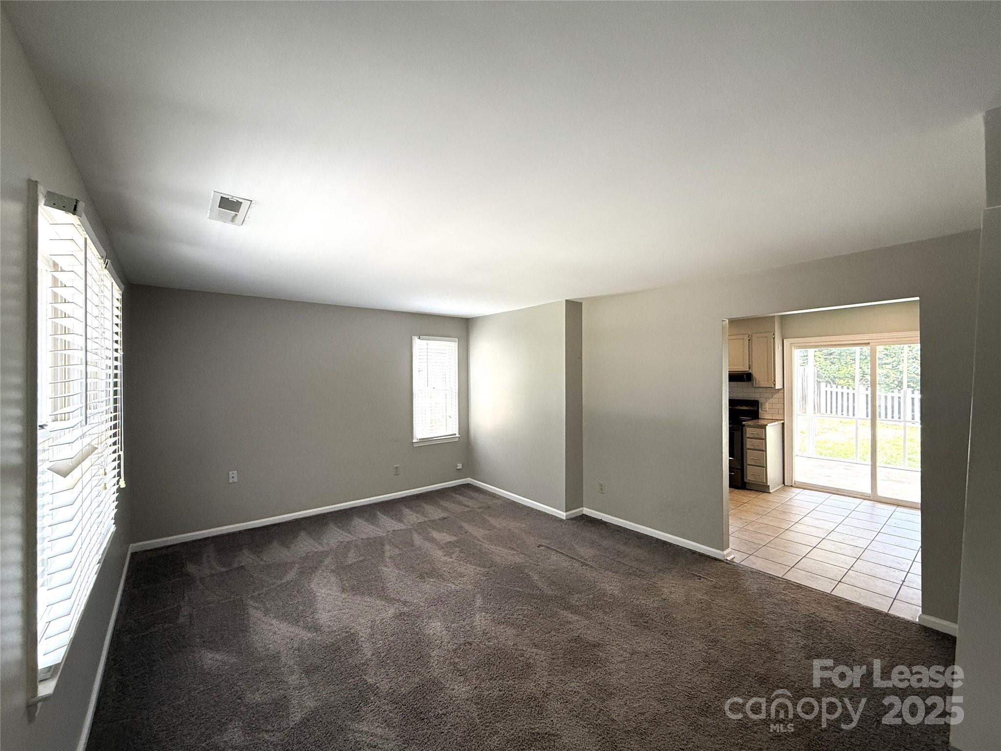 420 Beaty Street Davidson, NC 28036 - Photo 2 of 15 an empty room with windows and closet