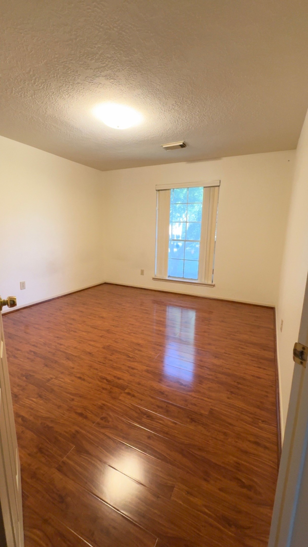 14731 Ridgechase Lane Houston, TX 77014 - Photo 17 of 37 an empty room with wooden floor and windows
