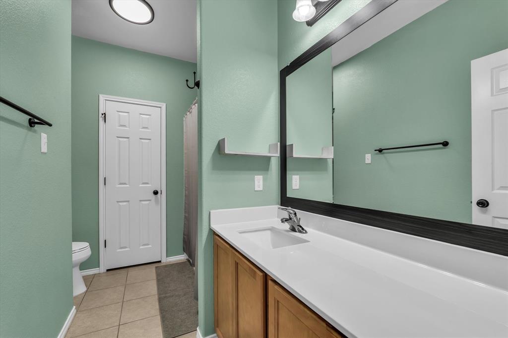 9453 Centennial Drive Waco, TX 76708 - Photo 10 of 37 a bathroom with a double vanity sink and mirror