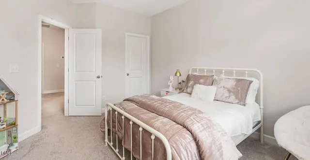 a bedroom with a bed and a lamp