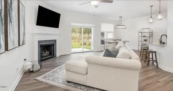 a living room with furniture a fireplace and a flat screen tv