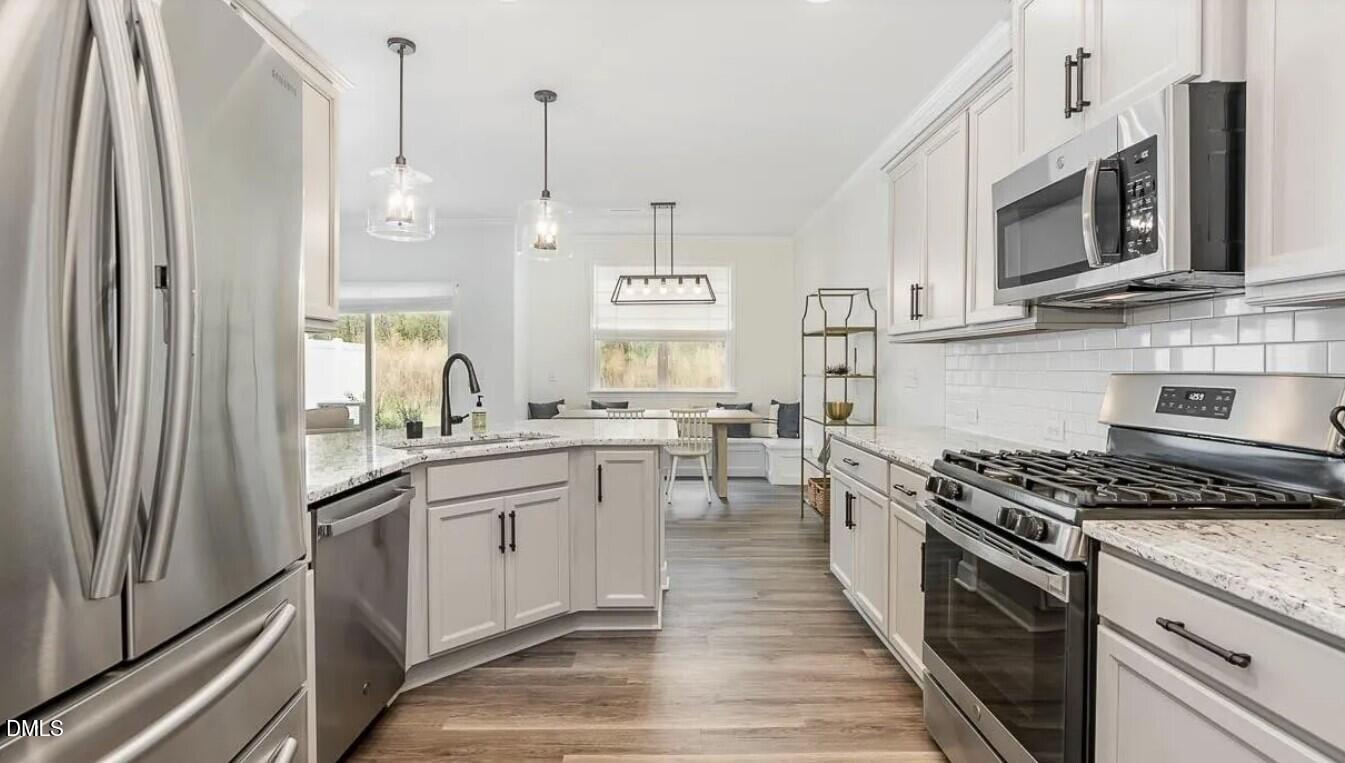 212 Bridge Point Drive Rolesville, NC 27571 - Photo 8 of 13 a kitchen with stainless steel appliances a stove a sink and a refrigerator