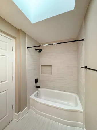 a bathroom with a shower and a bath tub