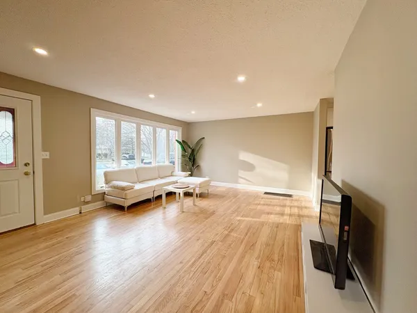a living room with a couch and a wooden floor